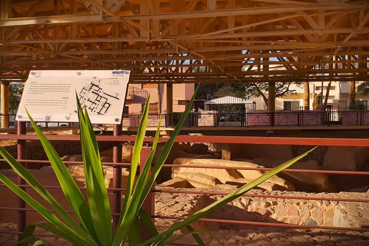 Aqaba Church — Viewing from the perimeter Railings and interpretation panels beside the sheltered Aqaba church ruins